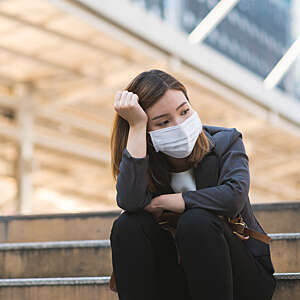 Businesswoman depressed sitting on a path.